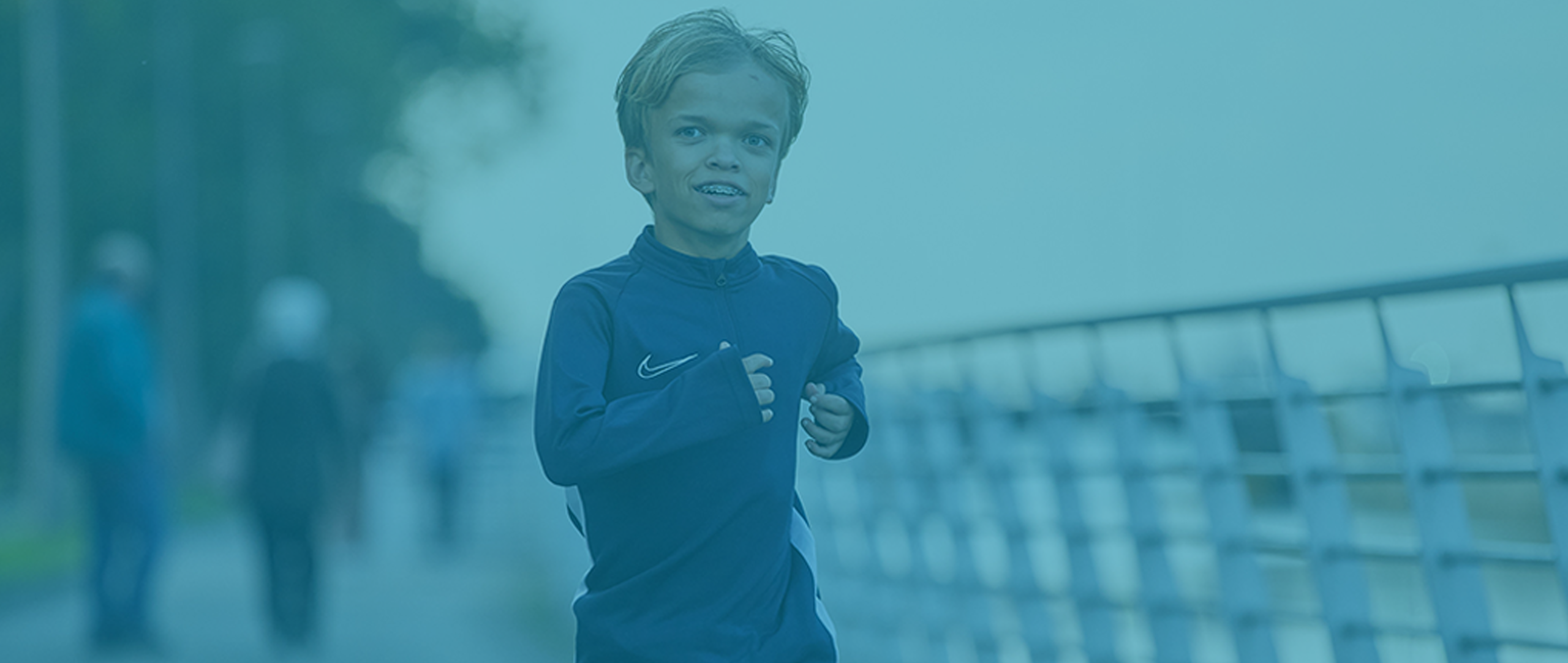 a boy with Achondroplasia wearing braces and running clothes